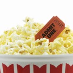 Bucket of popcorn with a admit one movie ticket, isolated on white